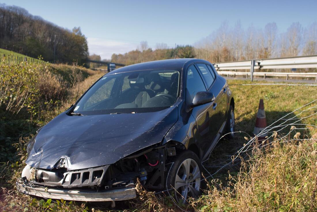 Wrecked car stuck in a ditch after an accident in Alpharetta, Georgia